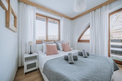 a bedroom with a bed with two pillows on it at WHY NOT Apartamenty widokowe PANORAMA in Kościelisko