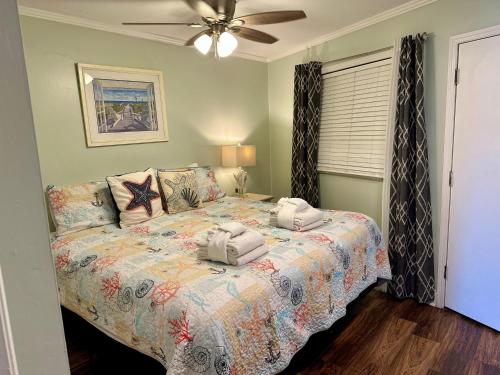 a bedroom with a bed with two towels on it at Seaside 278 in Hilton Head Island