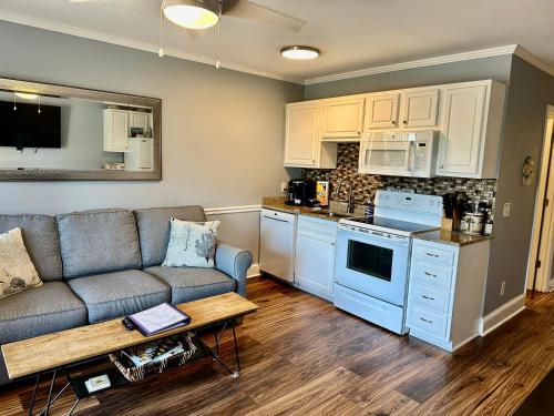 a living room with a couch and a kitchen at Seaside 278 in Hilton Head Island