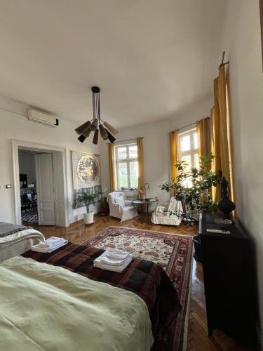 a bedroom with a large bed and a living room at Historijski luksuz u Starom Gradu, Garage Parking in Sarajevo