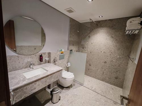 a bathroom with a sink and a toilet and a mirror at HDN Hotel فندق هدن in Mecca