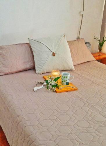 a bed with a tray with an umbrella on it at Kalma in Villa Elisa