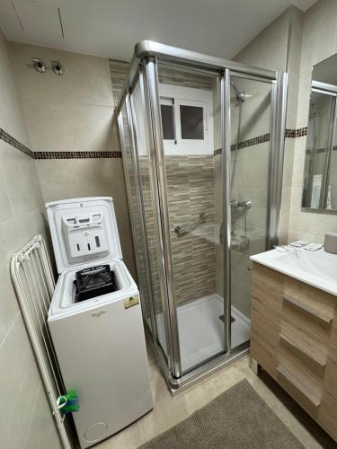 a small bathroom with a stove and a shower at Minerva 211 - 24h reception - 1 bedroom in Benalmádena