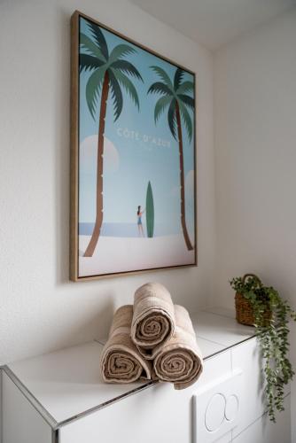 a picture of a beach with palm trees and towels at SaLi - Design Apartments in Trossingen