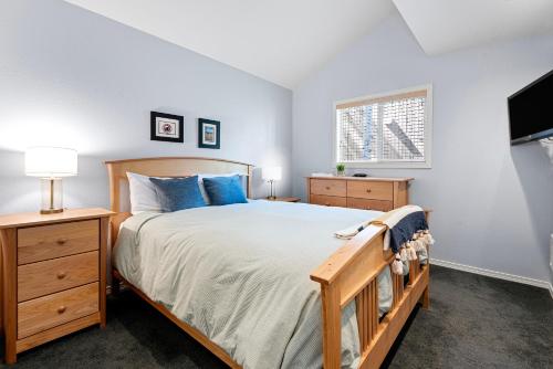 a bedroom with a large bed and a tv at Ski House 217 in Bend