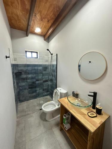 a bathroom with a shower and a toilet and a sink at Carpe Diem in Ocean Park