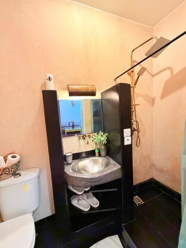 a bathroom with a sink and a toilet at Beldi House in Marrakesh