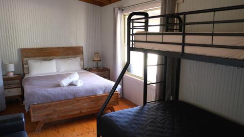 a bedroom with a bunk bed with a white pillow on it at Lovedale Cottages Hunter Valley in Lovedale
