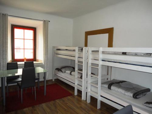 a room with two bunk beds and a desk at Rentcenter79 in Vordernberg