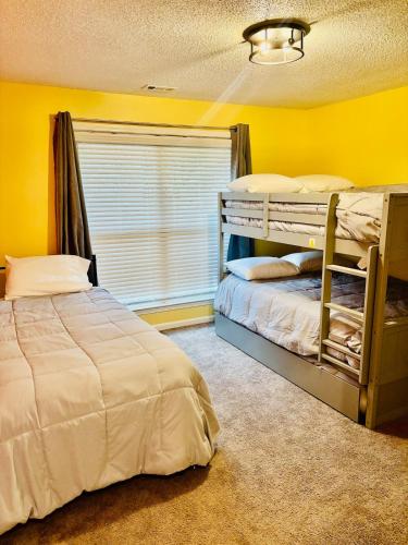a bedroom with two bunk beds and a window at The Williamsburg Haven in Williamsburg