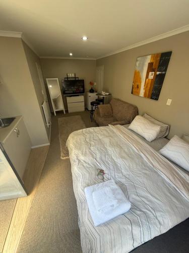 Un dormitorio con una cama y una sala de estar. en Casa Miguelle a Private mini house, en Dunedin