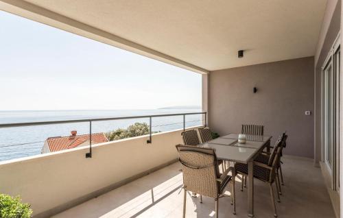 a dining room with a view of the ocean at Cozy Apartment In Dingac With House Sea View in Gornji Dingač