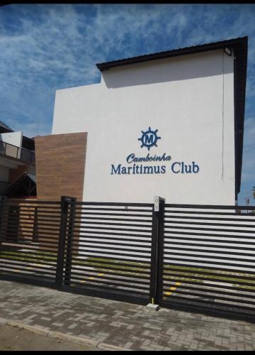 a building with a sign on the side of it at Bangalô Camboinha triplex in Cabedelo