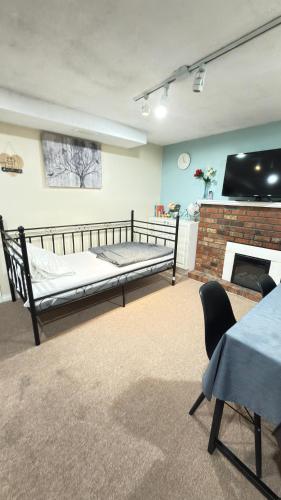 a living room with a bed and a fireplace at Sabrina's Home in Delta