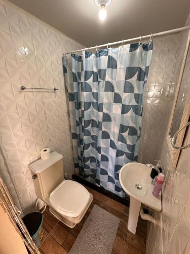 a bathroom with a toilet and a sink and a shower at Pousada por do sol in Niterói