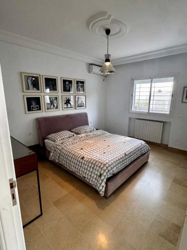 a bedroom with a bed and a table in it at Adagio House - Best View - Marsa Gammarth Sup in La Marsa