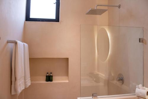a bathroom with a shower with a glass door at Peregrina Tulum 301C 1BR Condo in Tulum