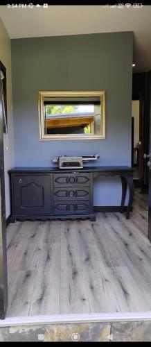 a room with a dresser with a mirror on the wall at Casa Palguin in Minetué