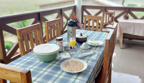 Grand-PopoGuesthouse Bambou Beach的一张桌子,上面有蓝色桌布,上面有食物