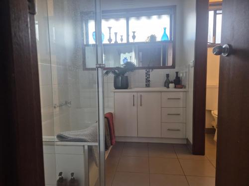 a bathroom with a shower and a sink at Retro Revival - Fondue, Flares & Feeling Groovy in Ocean Grove