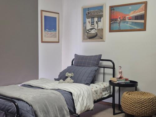 a bedroom with a bed with a stuffed animal on it at Retro Revival - Fondue, Flares & Feeling Groovy in Ocean Grove