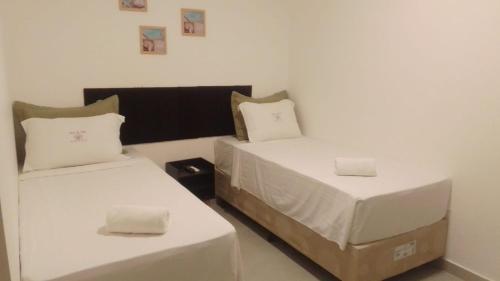 En eller flere senge i et værelse på Hotel Rosa da Ilha Guaruja - 80m do mar, 02 piscinas, sala de jogos, brinquedão de percurso para crianças