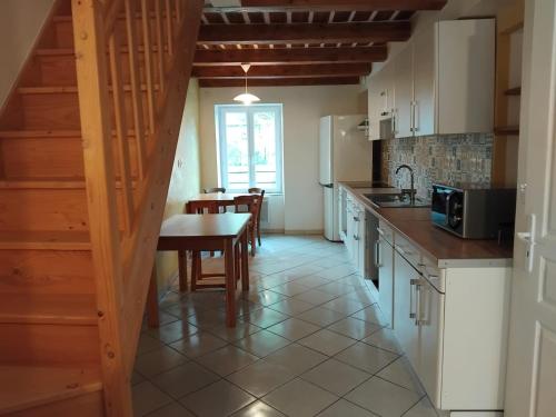 a kitchen with a table and a dining room at L'appartement d'Ananda in Villefranche-de-Rouergue