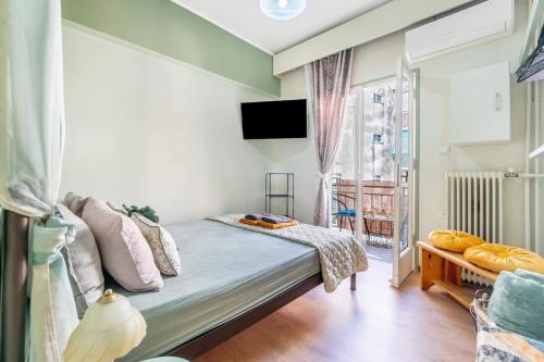 a living room with a couch and a window at Verdea Suite in Ágios Rókkos
