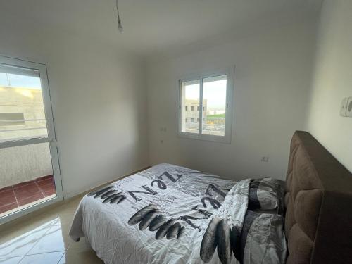 um quarto com uma cama em um quarto com janela em Farah airport résidence em Tânger