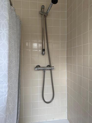 a shower with a shower head in a bathroom at 3-Bed House Brighouse Parking Wi-Fi Near M62 in Brighouse