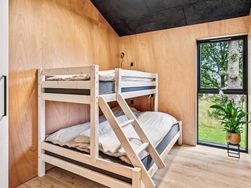 a bunk bed in a room with a window at 5 star holiday home in Skals in Skals