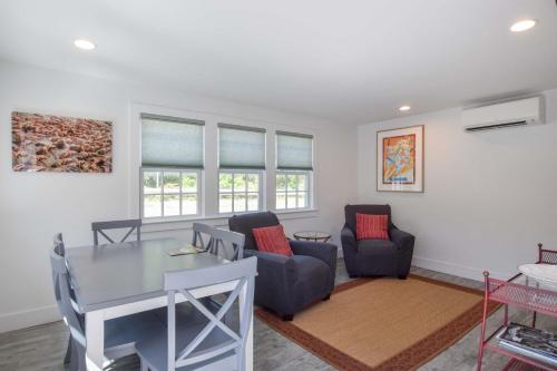 a living room with a table and two chairs at Condo w Beach Access & Water Views in Provincetown