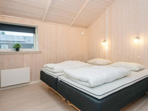 a large bed in a room with a window at 5 star holiday home in Ansager in Ansager