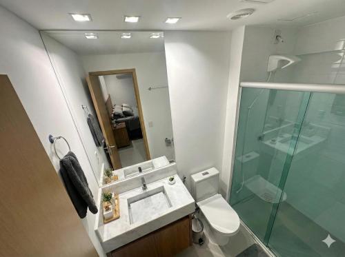 a bathroom with a sink and a glass shower at Studio Premium com lazer completo , ótima localização in Goiânia