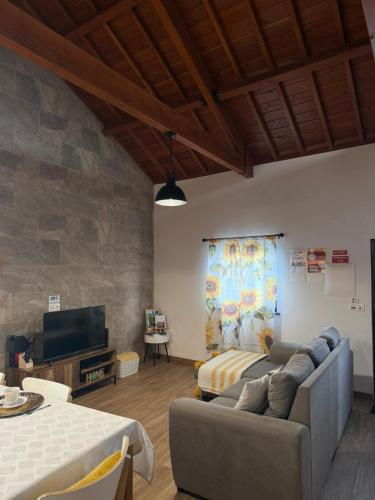 a living room with two beds and a couch at Refúgio das Pedreiras in Praia da Vitória