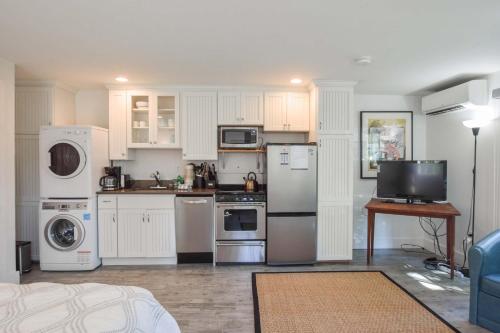 a kitchen with white cabinets and white appliances at East End Condo w Beach Access in Provincetown