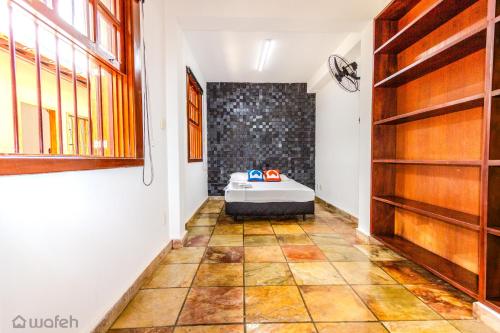 a room with a bed in the middle of a room at Hostel Wafeh Fleming in Belo Horizonte
