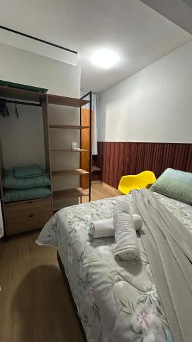 una camera da letto con un letto con asciugamani sopra di Loft das Flores a Pomerode