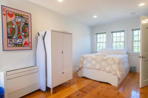 a bedroom with a bed and a dresser at East End Condo w Beach Access in Provincetown
