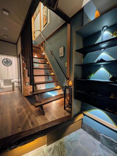 a staircase in a house with a blue wall at Chronos House Tokyo Kitasenju - Time Travel Stay in Tokyo