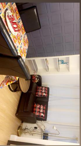 a corner of a room with a table with coca colas at Cozy & Comfy Apartments Dundee in Dundee