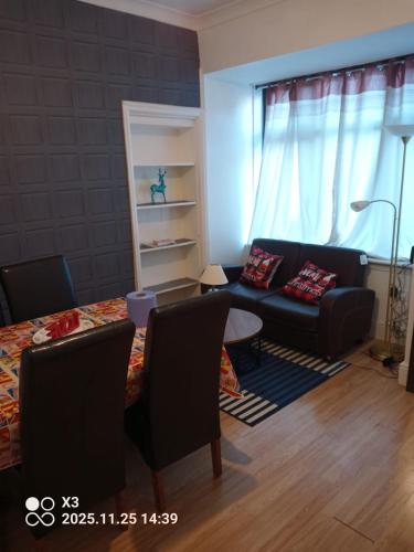 a living room with a couch and a table at Cozy & Comfy Apartments Dundee in Dundee