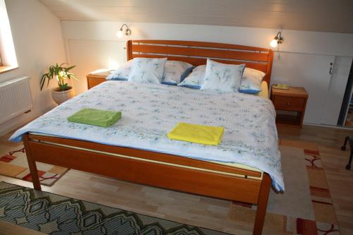 a bedroom with a large bed with two towels on it at Apartment BENCI in Jindrichuv Hradec