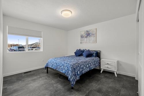 a bedroom with a bed with blue pillows on it at SilverStrike Condos Family Friendly Walkable Location Unit 2 in Kellogg