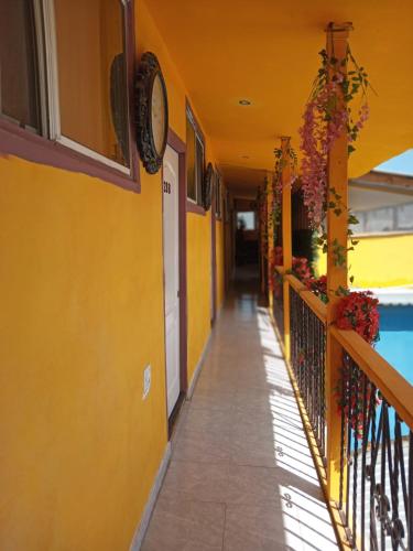 a hallway of a building with a clock on the wall at Hospedaje Barato Mi Casita de Colores in Tijuana