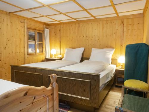 Un dormitorio con una cama grande en una habitación de madera. en Sixhäusl, en Kirchberg in Tirol
