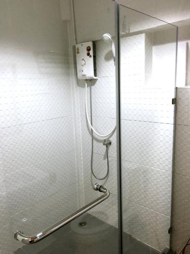 a shower stall in a bathroom with a glass door at Urban Hostel Bangkok in Bangkok