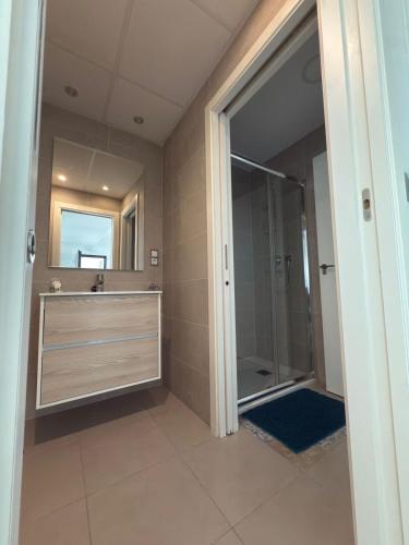 a bathroom with a shower and a sink and a mirror at Arenales SLB in Arenales del Sol
