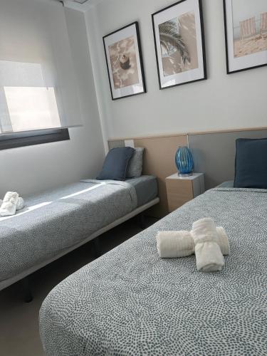 a bedroom with two beds with towels on them at Arenales SLB in Arenales del Sol