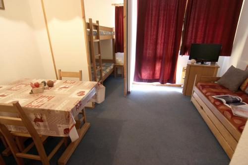 a room with a table and a bed and a couch at Zenith Appartements VTI in Val Thorens